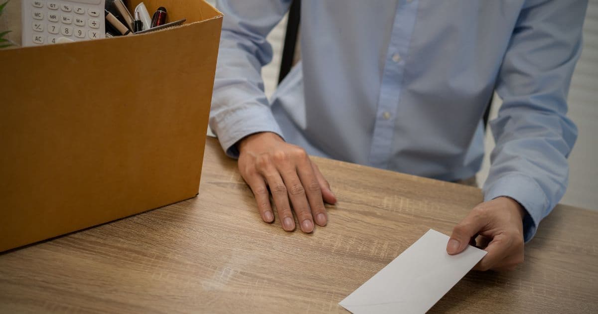 Professional writing a short resignation letter email in 2026 on a laptop, clear and formal notice to employer